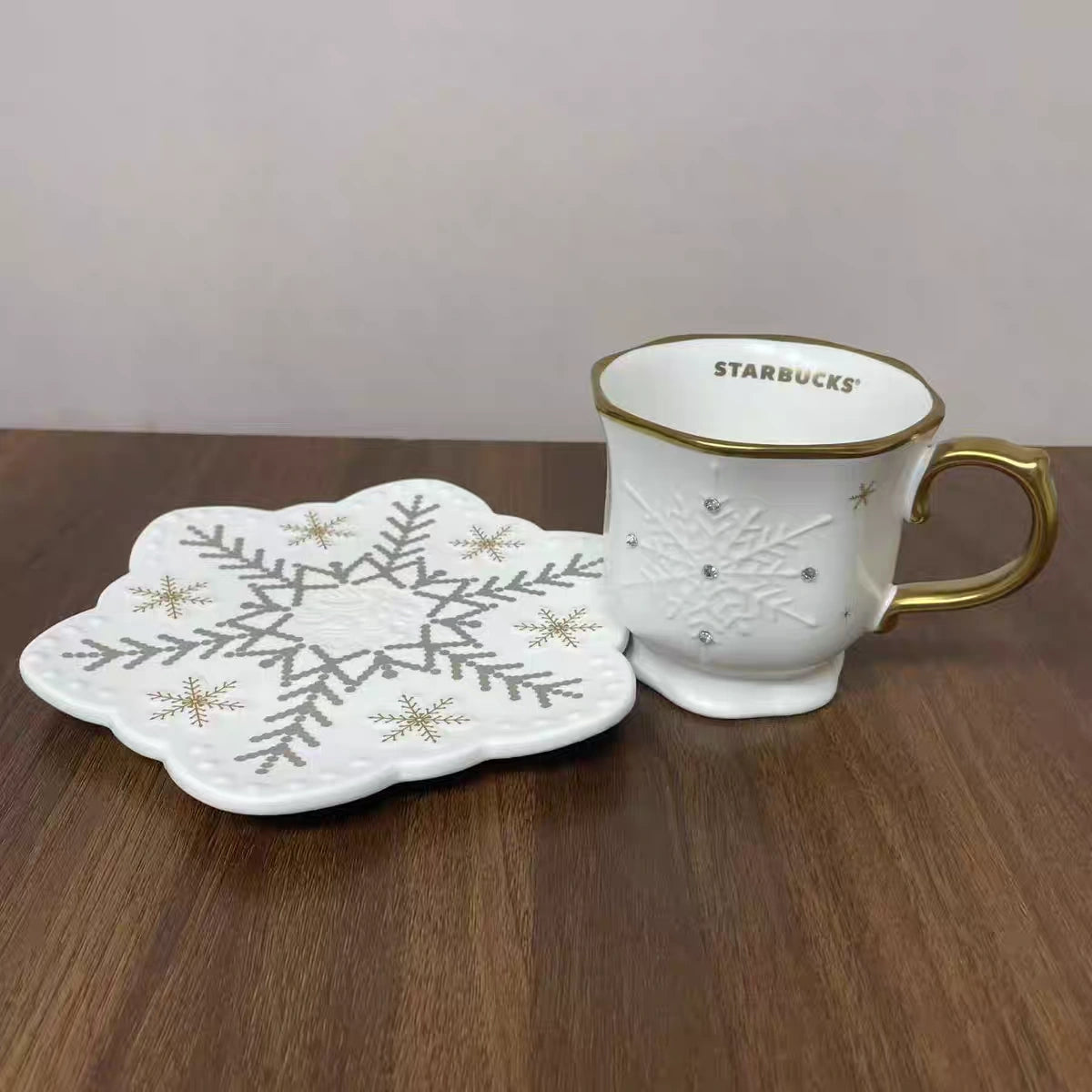 starbucks Ceramic Mug with Snowflake pattern Saucer set on desk
